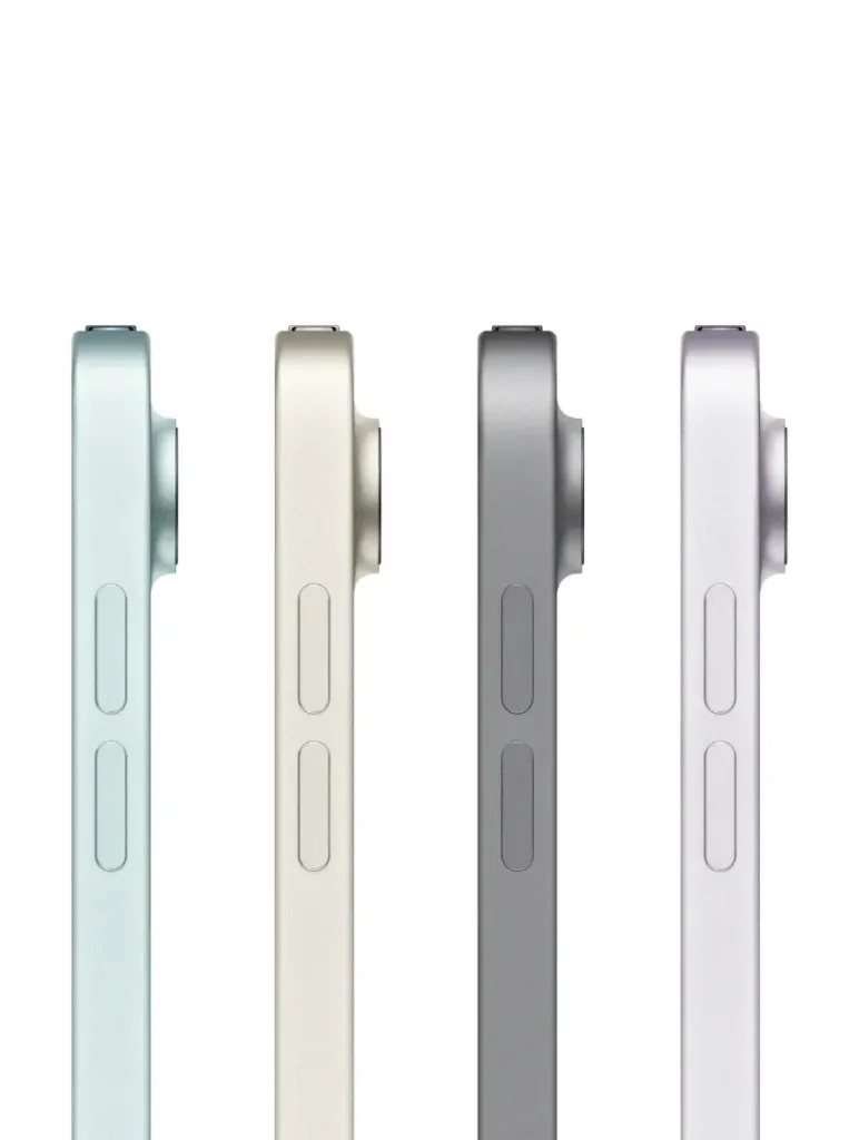A close-up shot shows the top right corners of four Apple iPad Air (2025) models in different colors: light blue, beige, space gray, and silver. Each iPad displays the rear camera lens and a portion of the side with volume buttons.