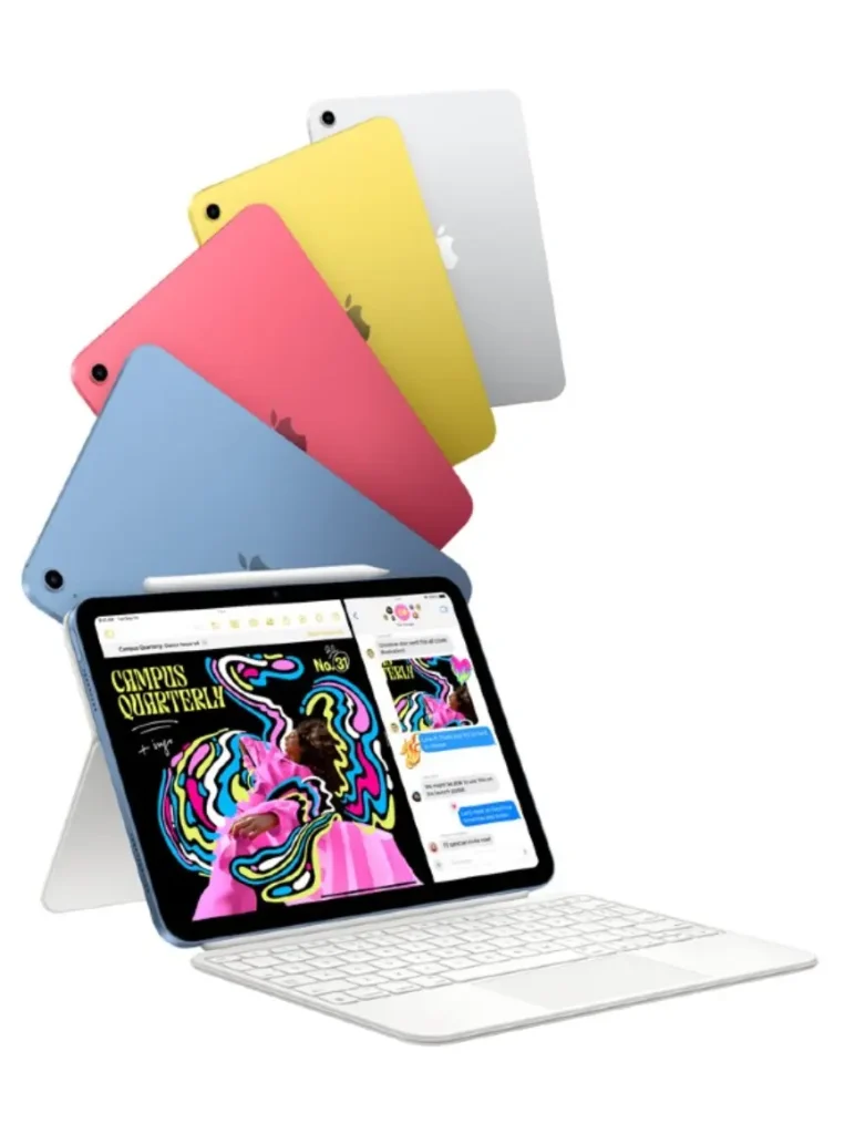 Five iPad Airs are arranged against a white background. Four iPads in blue, pink, yellow, and silver are stacked diagonally in the upper half. Below them, a blue iPad is in use with a white stand and keyboard, showing a colorful magazine design on its screen and an Apple Pencil resting on top.